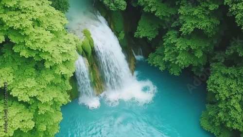 Serene Waterfall Surrounded by Lush Green Foliage in Nature Scene