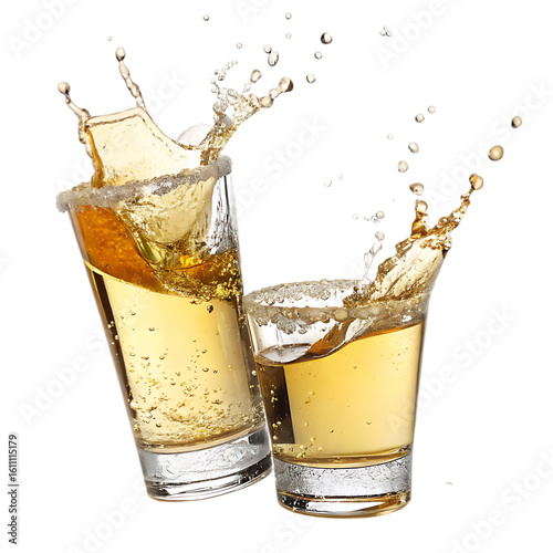 Two glasses of amber liquid splashing against a black background