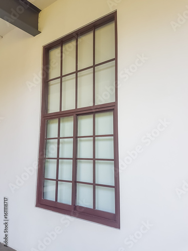 rectangular window with multiple panes  set with a white wall.