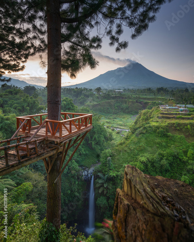 Photography The breathtaking waterfall and mountain scenery at dawn offers a serene experien