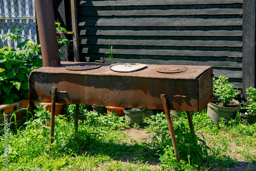 Fototapeta Naklejka Na Ścianę i Meble -  A metal stove with burners for cooking food outdoors.