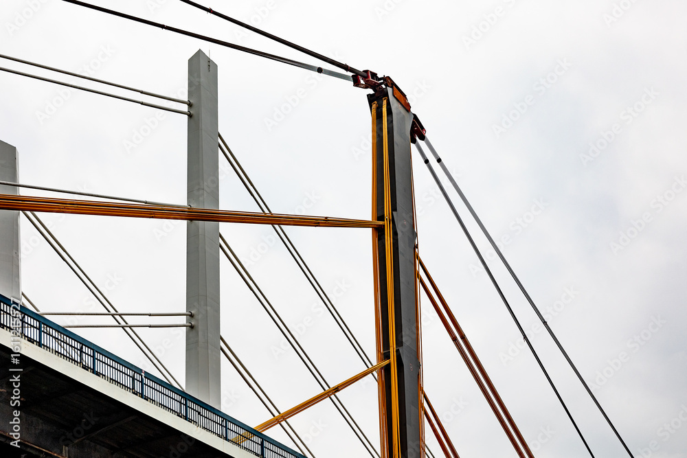 Fototapeta premium Crane lifting cables and electrical wires during bridge construction