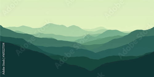 Blue-hued mountain range at dawn shrouded in ethereal fog and mist, offering a tranquil scenic view