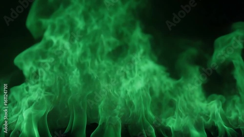 Abstract mesmerizing vibrant green fire flames burning against a black background, captivating