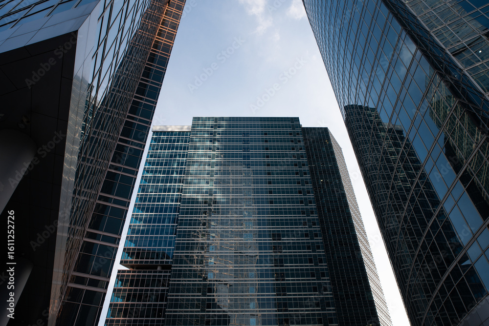 Naklejka premium view from below of tall skyscrapers and the sky