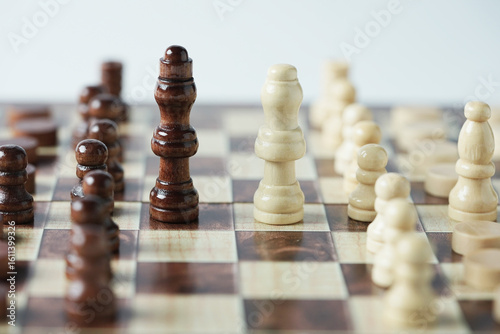 The confrontation between chess brown king and white queen. Chess pieces in chess board games for business, challenge, leadership, strategy and success.