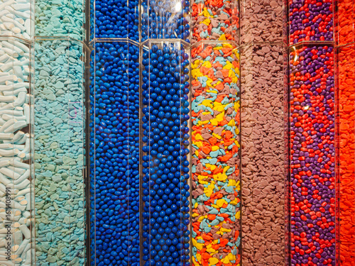 Transparent plastic tubes full of thousands of colorful candies
