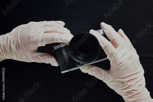 A camera and a gloved hand.