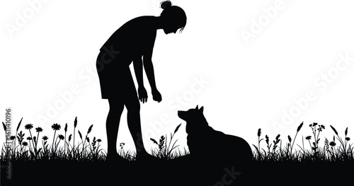 Silhouette of woman training dog in grass, obedience lesson in nature, pet owner bonding with loyal canine companion outdoors