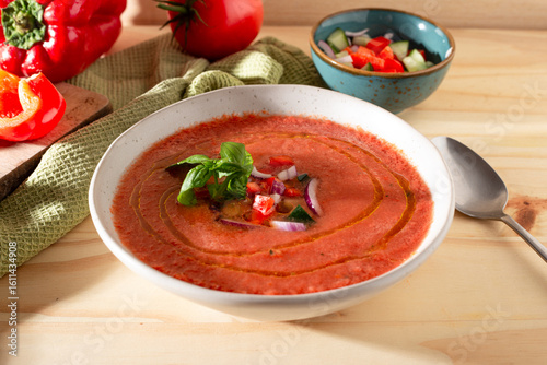 Fresh tomato and bell pepper gazpacho with basil and onion — overhead, natural light.CR2+JPEG