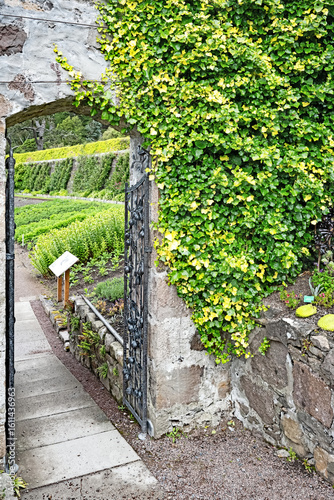 A stone doorway into a beautiful walled garden.