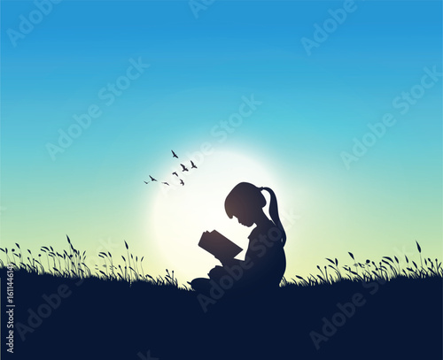 A kid reading outside on field. learning concept.