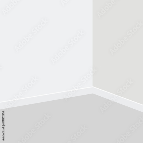 A corner of a room with white walls and gray floor and white baseboard trim view