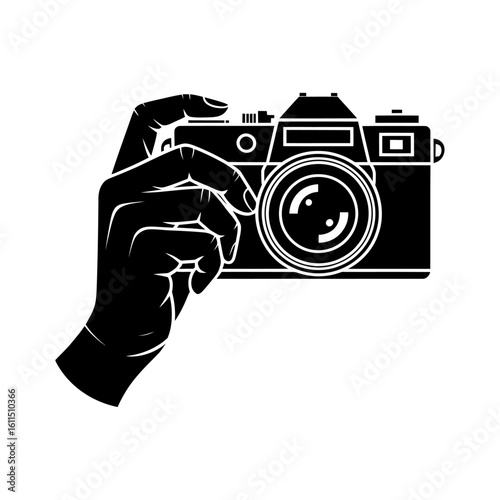 silhouette of a hand holding a vintage camera