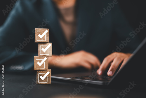 Konstfotografi Businessman planning checklist using wooden cubes with check marks, productivity goal setting and time management strategy concept for corporate success and effective work organization