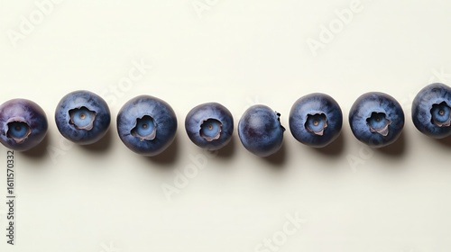 Minimalist row of fresh blueberries on white background
