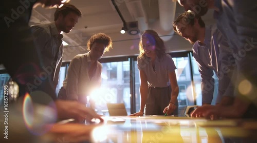 A low-angle, cinematic shot of a diverse business team collaborating around a table, with bright lens flares and engaging interactions, ideal for themes of teamwork, innovation, and modern workplace
