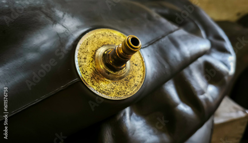Photos Butyl rubber envelope and metal valve stem used as auxillary materials in the ti