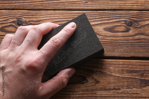 Принти на полотні Man's hand sanding wooden boards with a sanding block