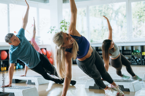 Mixed group trains together at the gym with energy and motivation during a fitness workout
