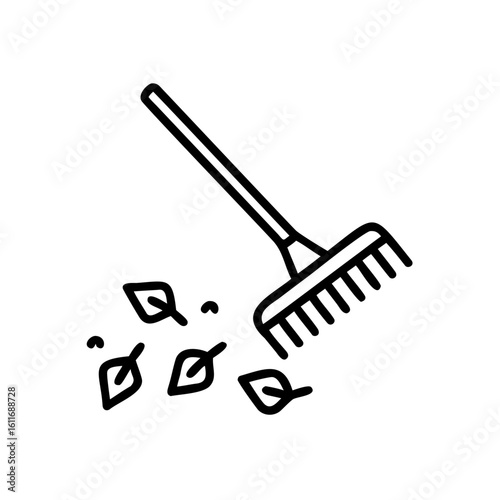 Outline garden rake with scattered leaves on tool autumn