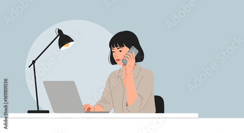 Woman with Short Black Hair Working on Laptop While Talking on Phone.