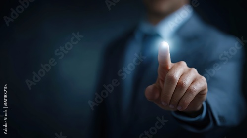 Business Professional Touching Light with Finger in Dark Background