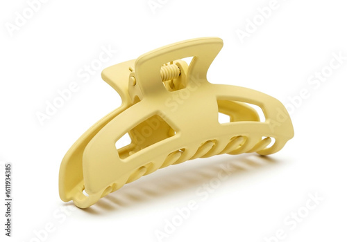 A matte yellow claw hair clip isolated on white background