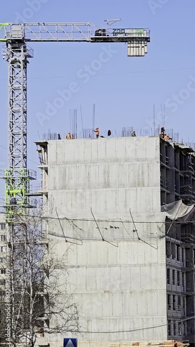 Construction workers building a concrete residential building