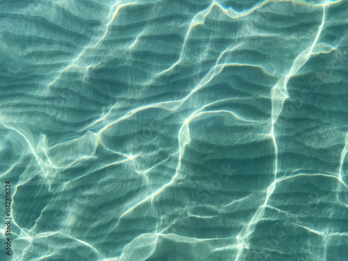 Light reflection on the sea sand bottom through transparent water, Abstract textured background wallpaper
