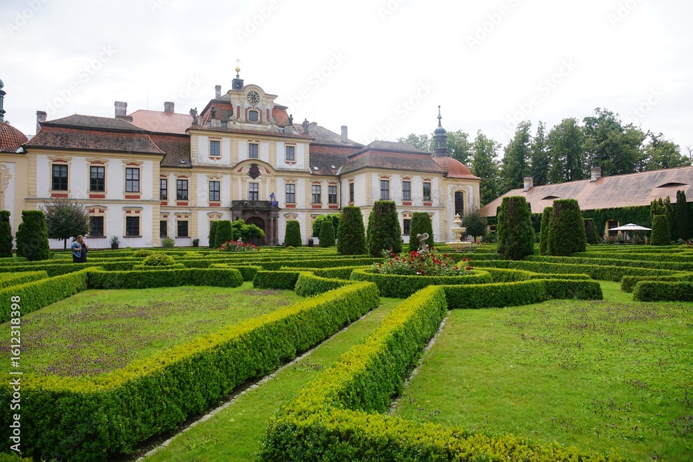 Obraz premium Historic European mansion with manicured gardens.