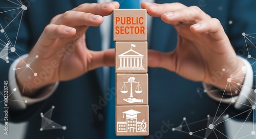 A businessman carefully holds stacked blocks representing key aspects of the public sector.