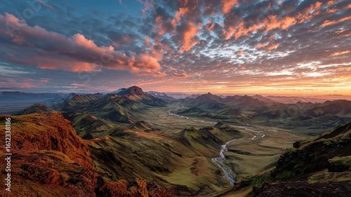 Breathtaking Panoramic View of a Vast Mountain Valley with a Winding River and Colorful Sunset Sky