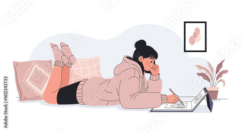 Creative Young Woman Drawing On The Floor In Her Apartment Using A Sketchpad