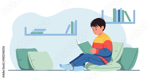 Boy Enjoying Reading A Book Sitting Comfortably On Pillows At Home