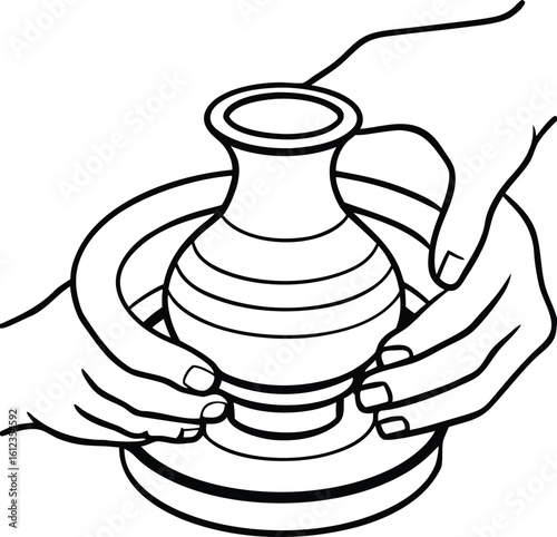 Hands shaping clay on a pottery wheel creating a vase
