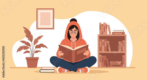 Young Woman Relaxing at Home Reading a Book Cross Legged on the Floor