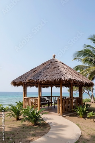 pavilion with bamboo frame and thatched roof by the ocean, tropical setting, natural materials, eco tourism concept