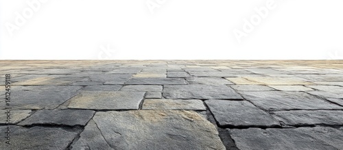 Close-up view of an uneven stone pavement with large weathered rectangular slabs stretching into the distance under natural light
