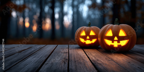 Two glowing jack-o’-lanterns on a rustic blank wooden table for product placement in a dark forest at twilight
