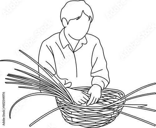 Person weaving a basket from natural reeds or grasses