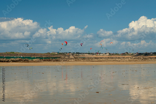 View of the coast of the city with beaches and kitesurfing enthusiasts on a sunny summer day, Saint-Malo, Brittany, France