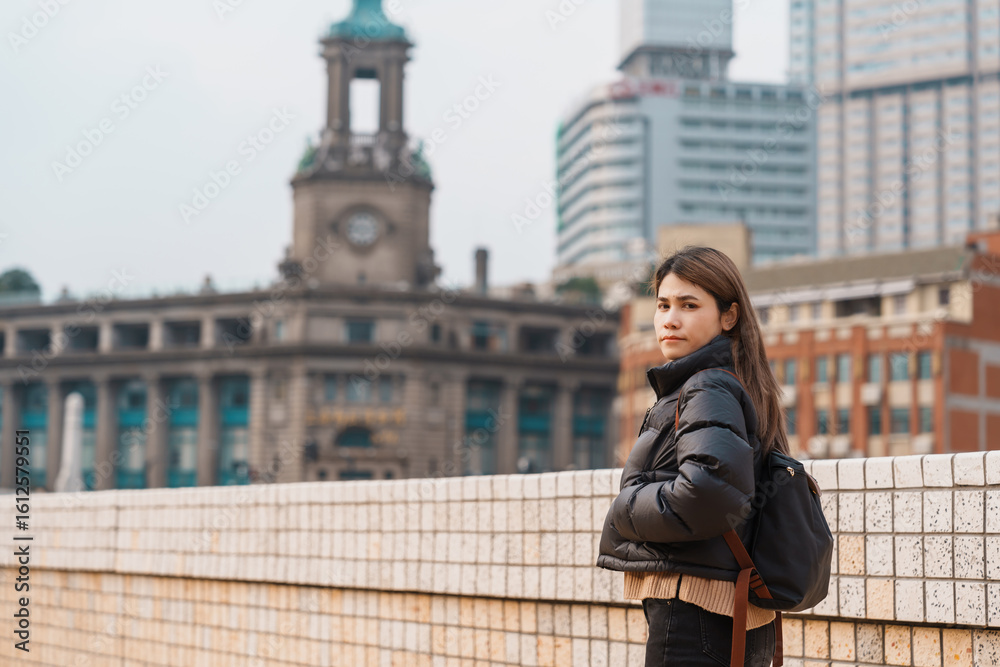 Fototapeta premium woman traveler visiting in Shanghai, China. Happy Female Tourist sightseeing Shanghai view. landmark and popular for tourism attractions. Travel and vacation concept