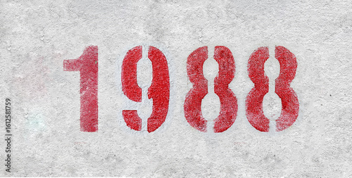 red spray-painted number 1988 sprayed onto a white wall.