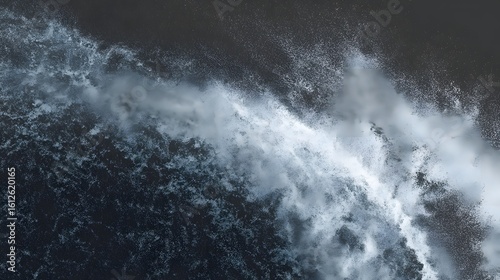 Dynamic ocean wave crashes with white spray against dark, textured seabed for powerful nature visuals