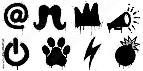Collection of stencil graffiti icons spray painted on a white background. The set includes an at symbol, mustache, crown, megaphone, power button, paw print, lightning bolt, and bomb explosion.