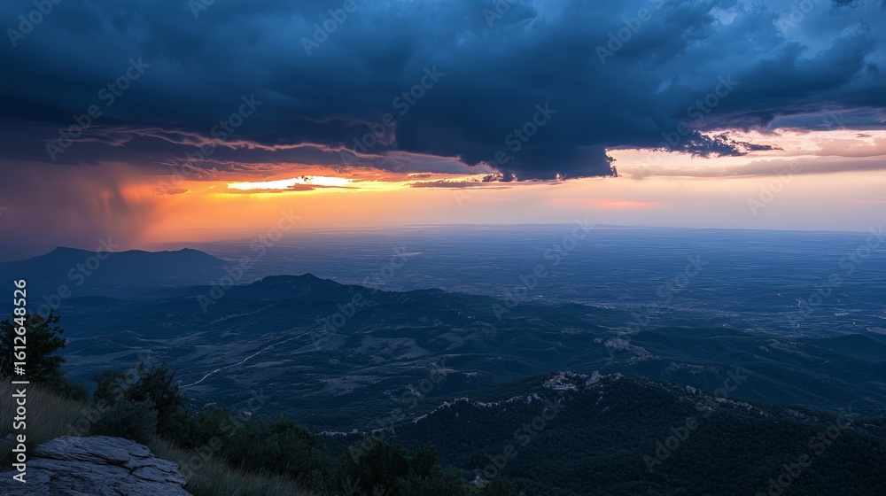 Obraz premium Dramatic sunset over mountain range, storm clouds