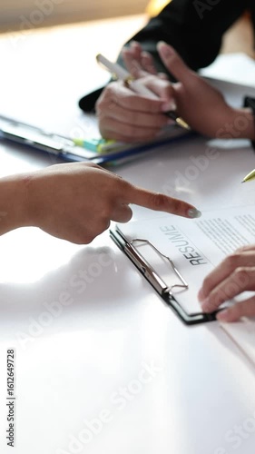 Employer explaining job description during interview. HR managers read resumes and asks candidates questions.
