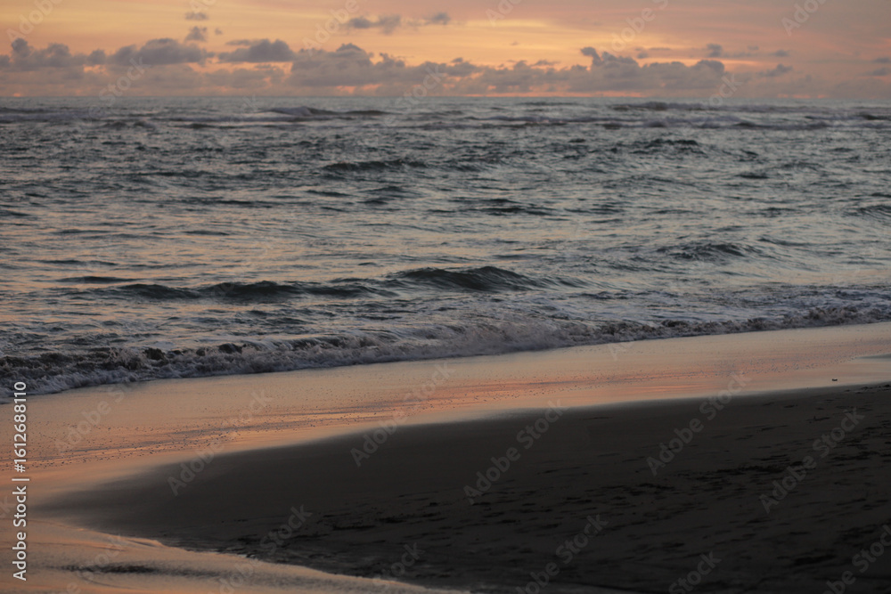 Fototapeta premium Orange Sunset with Soft Clouds over the Ocean