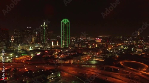 The dallas skyline glows at night with illuminated skyscrapers